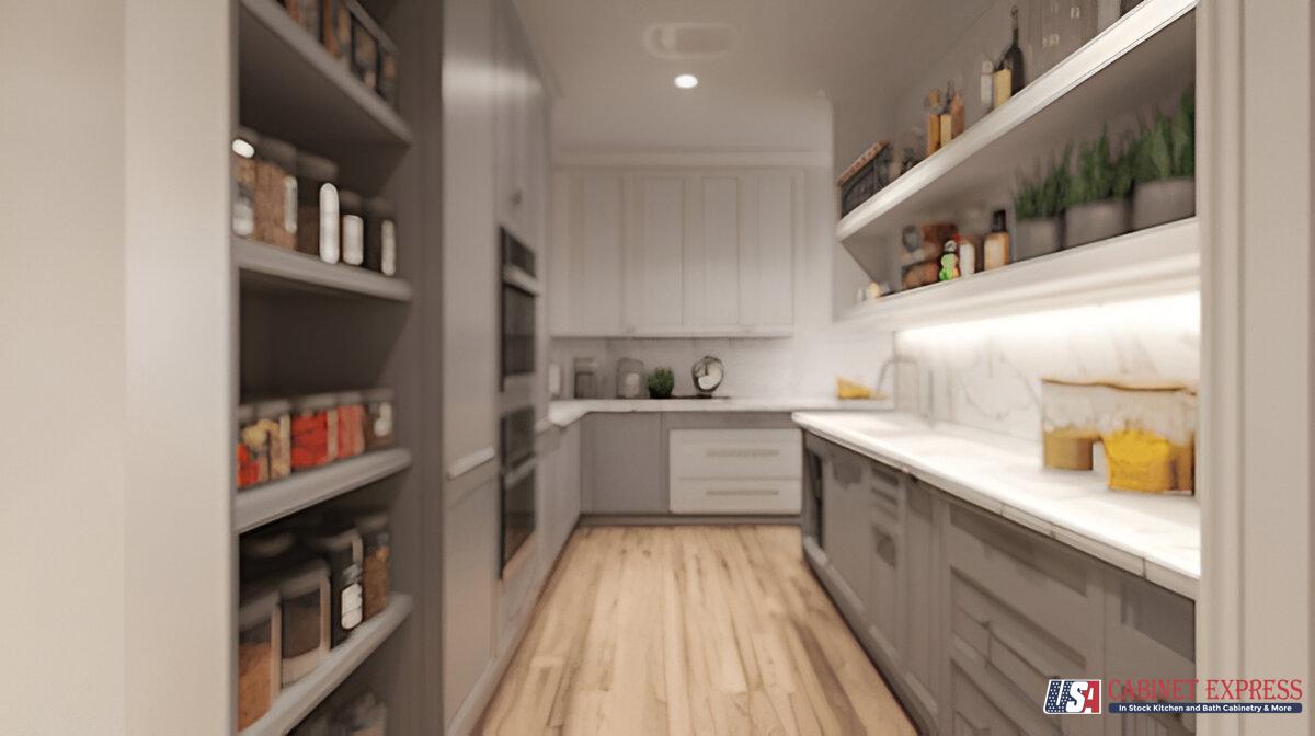 A modern pantry-style kitchen featuring gray and white cabinetry, open shelving stocked with spices and kitchen essentials, and marble countertops. The space is illuminated by under-shelf lighting, and wooden flooring adds warmth to the design. The USA Cabinet Express logo is visible in the bottom right corner.