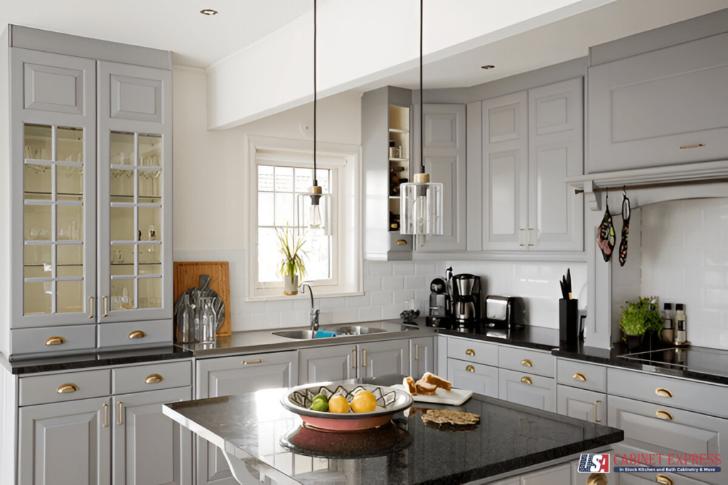 a kitchen with white cabinets and a bowl of fruit