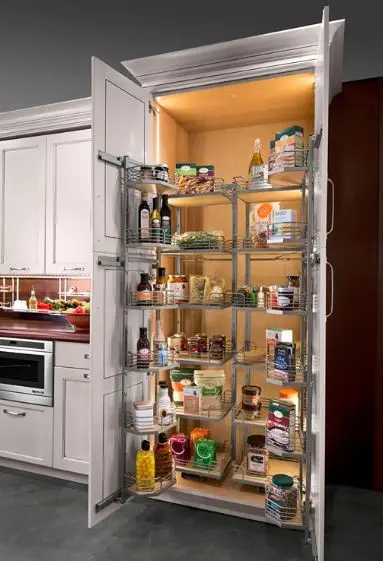 A spacious pull-out pantry with metal wire shelves and interior lighting, neatly stocked with dry goods, condiments, and kitchen essentials.