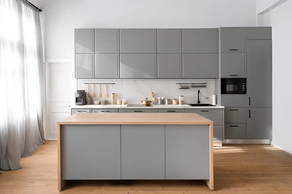 How to Organize Your Kitchen Cabinets Like a Pro (Step-by-Step Guide) 5 A modern kitchen with sleek gray cabinetry, a wooden island, minimalist decor, and a bright, airy atmosphere with natural light from large curtains.