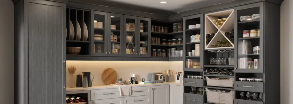 A sophisticated kitchen pantry with custom dark cabinetry, glass-front storage, built-in wine racks, and open shelving for an elegant and functional design.