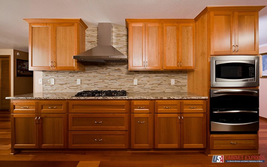 a kitchen with wood cabinets and marble counter tops